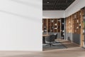 White open space office interior with bookcase and blank wall Royalty Free Stock Photo