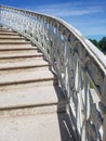 White openwork staircase leading to the sky.