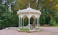 White openwork wooden gazebo for resting visitors to the city park