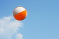 Beach ball flying on blue sky