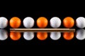 White and orange golf balls with bamboo chopsticks Royalty Free Stock Photo