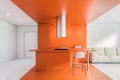 White and orange kitchen interior, bar and sofa Royalty Free Stock Photo