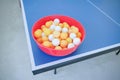 White and orange ping pong ball on ping pong table