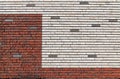 White and orange red brick wall interspersed with some gray bricks Royalty Free Stock Photo