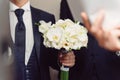 White Orchid Bouquet in Groom's Hand