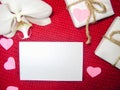 White orchid and gift box on a red background, Valentines Day background. Small paper hearts. Royalty Free Stock Photo