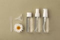 White organic pharmacy cosmetics flat lay with flower of camomile. Clean beauty concept. Branding mock up; top view on green back