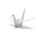 A white origami crane made from paper, resting on a plain surface. The crane features Royalty Free Stock Photo