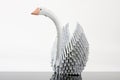 White origami swan on grey surface Royalty Free Stock Photo