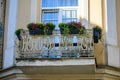 White ornate wrought iron balcony decorated with flowers