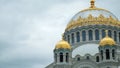 White Orthodox Church with big gold domes on a cloudy day. Concept. Beautiful big temple against cloudy sky, concept of Royalty Free Stock Photo