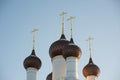 Few domes with crosses over a white-stone temple against a blue sky Royalty Free Stock Photo