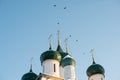 Few domes with crosses over a white-stone temple against a blue sky Royalty Free Stock Photo