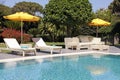 White outdoor furniture in the garden near the resort pool