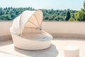 White outdoor furniture round rattan sofa with cushions, a place to relax on the terrace of the resort Royalty Free Stock Photo