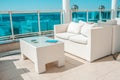 White outdoor furniture soft sofas and rattan chairs with cushions and a table with a glass top. Place to relax on the terrace of Royalty Free Stock Photo