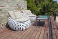 White outdoor furniture on wood resort terrace