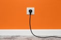 White outlet on orange wall Royalty Free Stock Photo