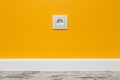 White outlet on yellow wall