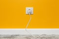 White outlet on yellow wall