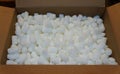 White packing peanuts inside a brown box