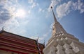 White pagoda with clouds and sky in the background in Wat Thong Noppakun