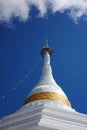 White pagoda wrapped by yellow fabric with blue sky