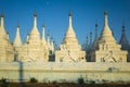 White pagodas of Sanda Muni Paya Buddhist stupa in Mandalay, Myanmar