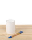White paint with a brush on a wooden background with texture Royalty Free Stock Photo