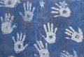 White paint handprints on a blue wall Royalty Free Stock Photo
