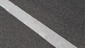 White paint line on asphalt road surface, with gray color guidelines on street Royalty Free Stock Photo