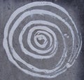 White paint spiral on gray grunge stone wall Royalty Free Stock Photo