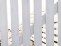 White paint wooden plakes fence in soft sunlight. Wood construction near sea. Beach bar wooden fence Royalty Free Stock Photo
