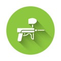 White Paintball gun icon isolated with long shadow. Green circle button. Vector Illustration