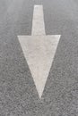 White painted arrow on grey asphalt road Royalty Free Stock Photo