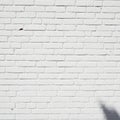 White painted brick wall with a uniform pattern of horizontal and vertical lines. The bricks are Royalty Free Stock Photo