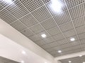 An White painted Emulsion painted for an gypsum ceiling with Macro Grid ceiling for an suspended false ceiling of an Shopping mall