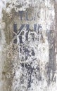 White painted metal pole with not legible text grunge texture