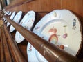 White painted plates in a decorative wooden stand Royalty Free Stock Photo