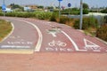 White painted Sign of a bicycle and pedestrian paths on the asphalt road. Royalty Free Stock Photo