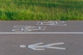 White painted signs of pedestrian lane and bicycle lane on asphalt road Royalty Free Stock Photo