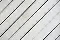 White painted wooden surface close-up. Rustic natural wooden diagonal planks with cracks, scratches for modern design