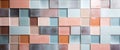 a white, pale, pink, orange, brown, yellow and rose colored wall of tiles