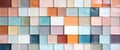 a white, pale, pink, orange, brown, yellow and rose colored wall of tiles