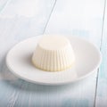 White panna cotta in a dish on white background