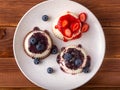 White panna cotta with strawberry in a dish on a wooden background