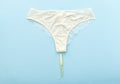 White pantie with menstrual tampon for mothly cycle on pastel colorful blue background. Flat lay with pantie. Menstruation,