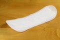 White pantyliner on a wooden background Royalty Free Stock Photo