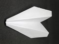 White paper airplane toy on black background Royalty Free Stock Photo