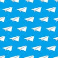 White paper airplanes over blue background, seamless pattern